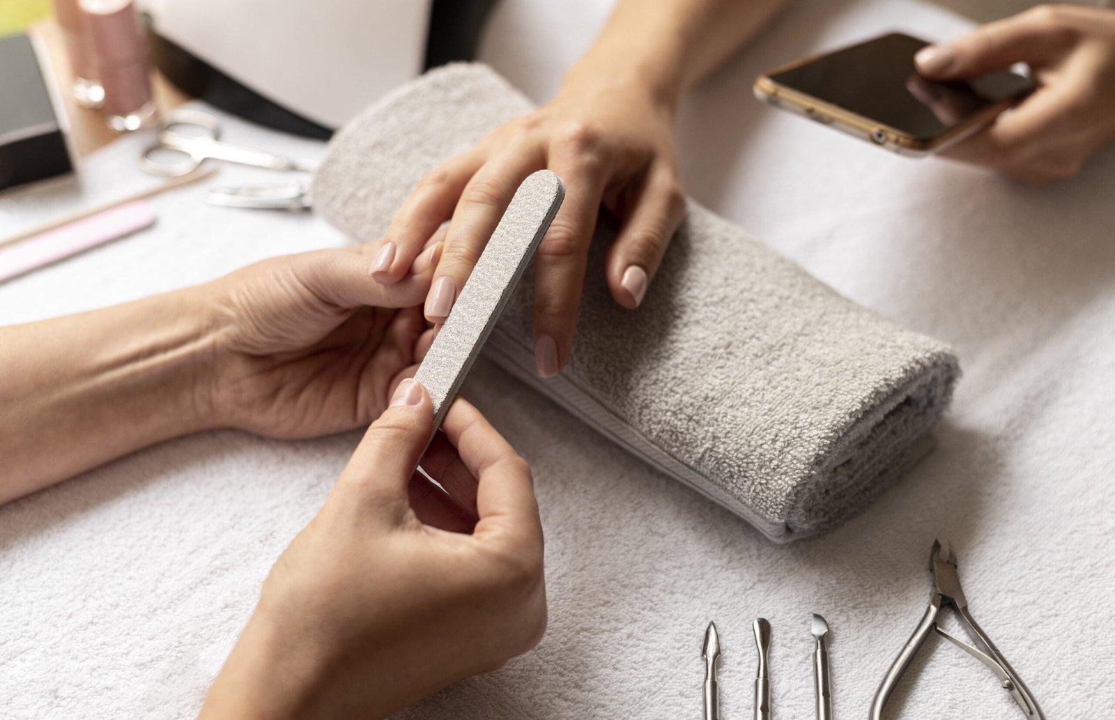 close-up-manicurist-holding-nail-file